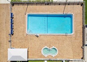 Ein oberirdischer, rechteckiger Pool mit Sprungbrett und einem kleineren, runden Pool.