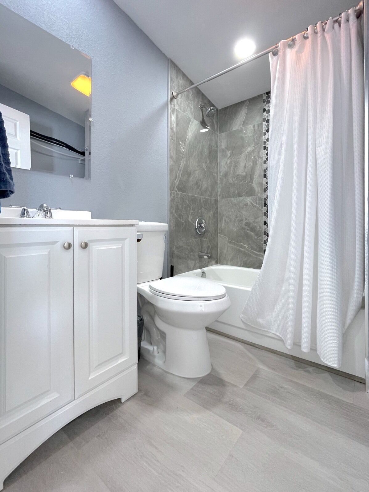 Un baño con ducha, inodoro y lavamanos.
