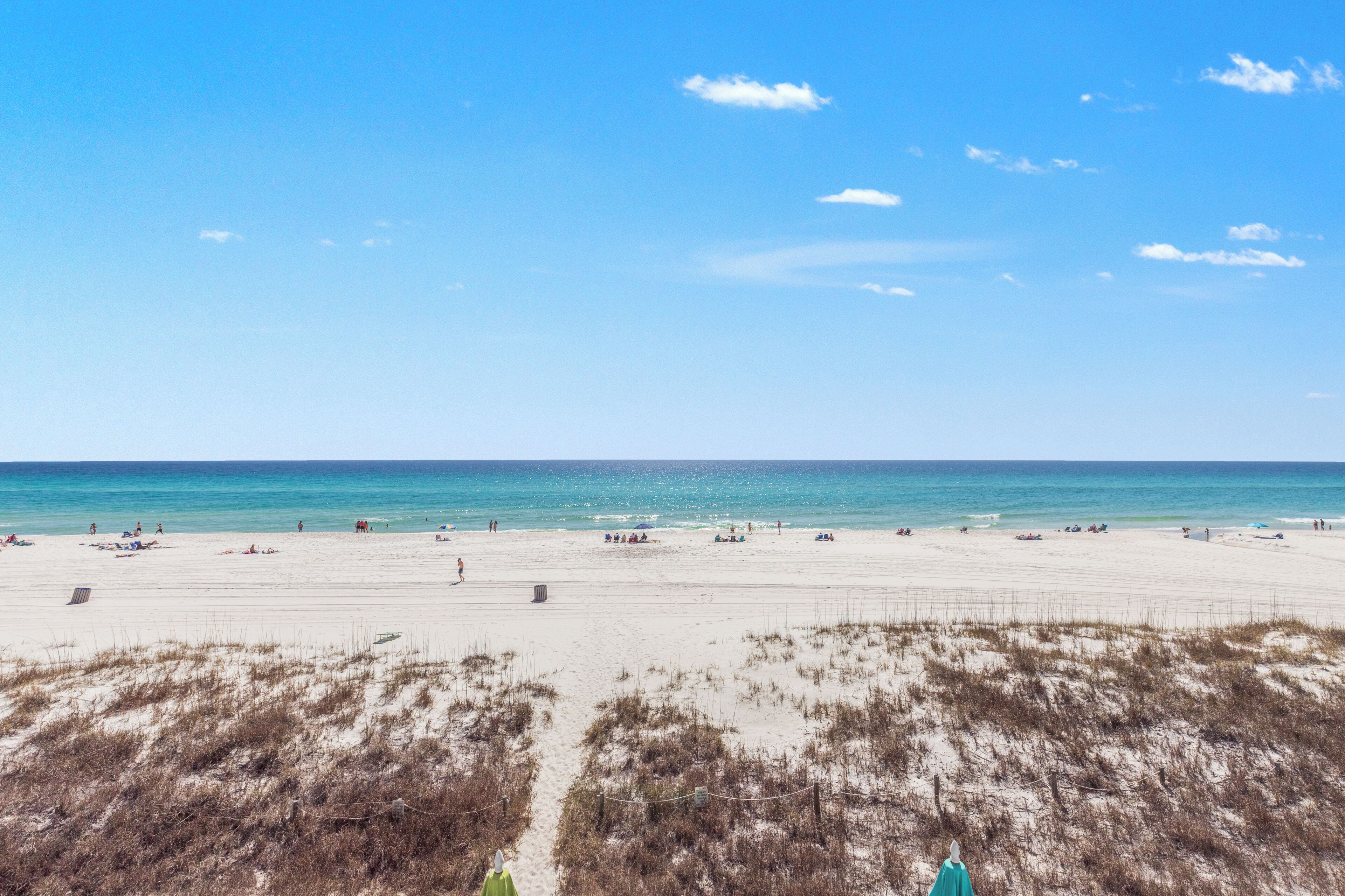 A beach with sand dunes and a clear sky.