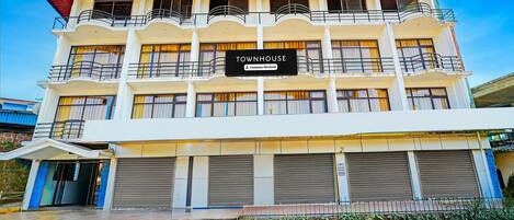 A multi-story building with a sign reading 'TOWNHOUSE.'