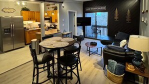 A modern kitchen with wooden cabinets, a built-in oven, and a refrigerator. - Walk to Weirs Beach Boardwalk with Treetop Views of Lake Winnipesaukee! (Laconia)