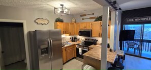 Fridge, microwave, oven, stovetop - Walk to Weirs Beach Boardwalk with Treetop Views of Lake Winnipesaukee! (Laconia)