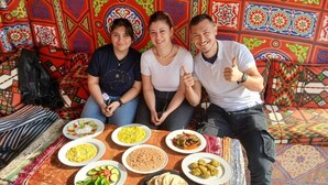 A group of people sitting at a table with various dishes in front of them. - Pyramids Essence hotel (Giza)