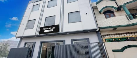 A modern building with a sign that reads "TOWNHOUSE Company Serviced."