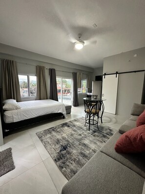 A modern bedroom with a bed, a desk, and a sofa. - Wonderful 5-bedroom house in lovely Port Antonio, convenient location (Port Antonio)
