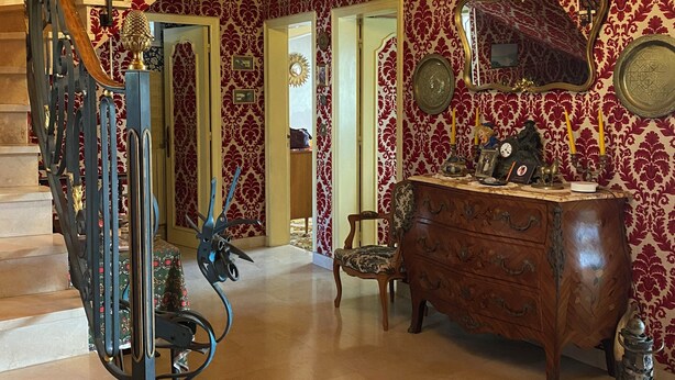 A grand staircase with ornate metal railings, a chandelier, and a patterned wallpaper interior. - Charming house in Le Faou, a "little town of character", between land and sea. (Le Faou)