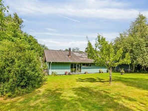 A single-story house with a green exterior, a chimney, and a covered porch. - "Niela" - 700m from the sea by Interhome (Græsted)