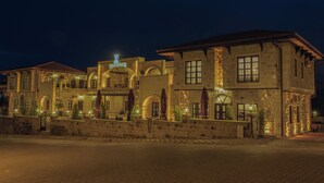 A historic building with arched windows and a prominent sign reading 'Noble Blue.' - Noble Blue Cappadocia  (Urgup)