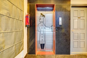 An elevator with a cartoon character, a fire extinguisher, and a door with the number 401. - Deluxetownhouse Sarjapur Near Bellandur (Bengaluru)