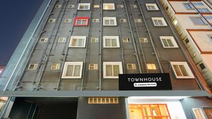 A multi-story building with a sign reading 'TOWNHOUSE Company-Serviced.' - Deluxetownhouse Sarjapur Near Bellandur (Bengaluru)