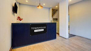 A reception desk labeled 'TOWNHOUSE' with a sign indicating 'Company-Served.' - Deluxetownhouse Sarjapur Near Bellandur (Bengaluru)