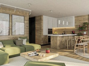 A modern living room with a green sofa, a coffee table with magazines and glasses, and a kitchen area with wooden cabinets and a bar. - Alphubel Peak & Unlimited by Interhome (Saas-Fee)