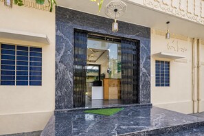 A building entrance with a marble floor, a glass door, and a decorative ceiling. - Deluxekhandaka Villa (Amer)
