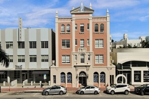 A multi-story building with a central entrance, large windows, and a classic architectural style. - Prime South Beach 1BR/1BA Beach 1 Min Away 301 (Miami Beach)