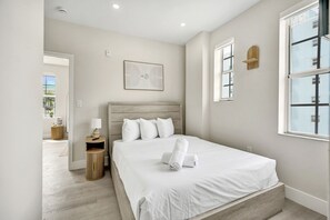 A bedroom with a bed, bedside table, lamp, and artwork. - Prime South Beach 1BR/1BA Beach 1 Min Away 301 (Miami Beach)