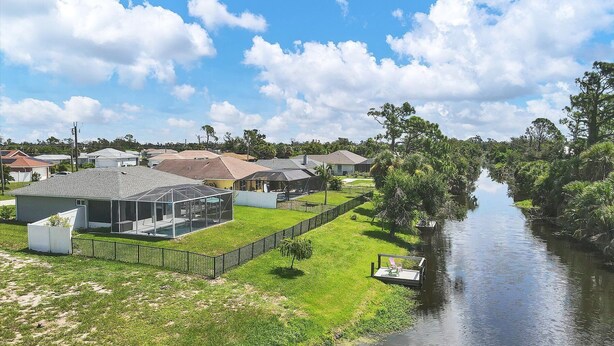 A residential area with houses, a swimming pool, and a river. - Coastal Englewood Retreat near beaches, golf and relaxing sunsets (Englewood)