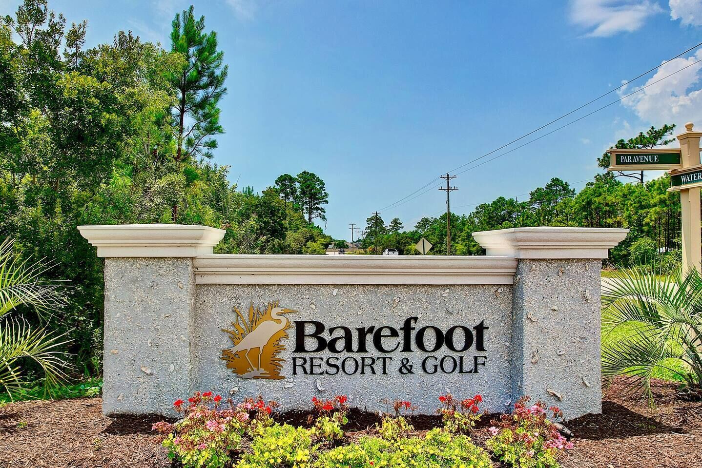 A sign for Barefoot Resort & Golf with a logo of a bird and the name.