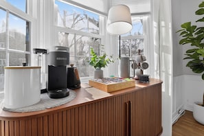 A kitchen counter with a coffee maker, a box labeled "Coffee&Tea," and a potted plant. - 5BR Toledo Retreat, Hot Tub, Sauna, Sleeps 14 (Toledo)