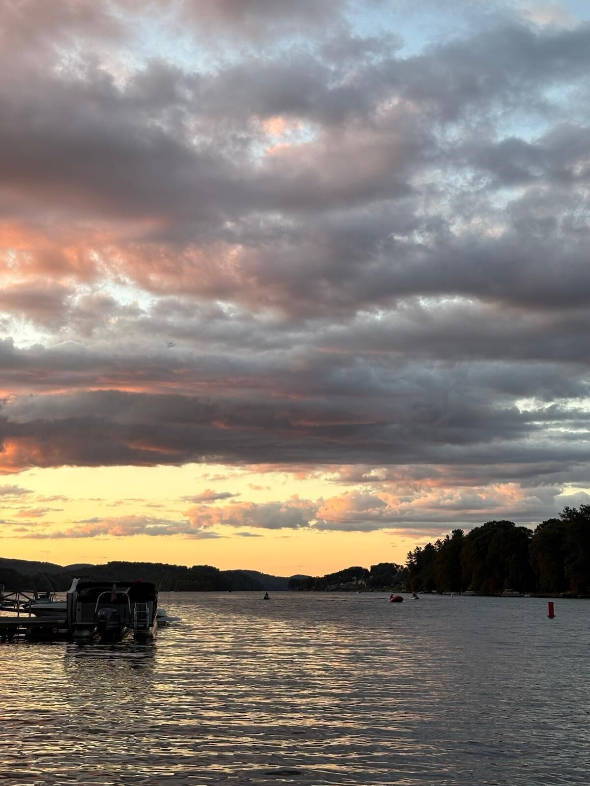 A body of water with a boat and a dock.