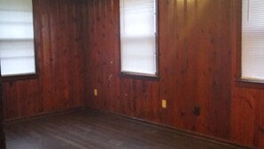 A room with wooden walls and a dark wooden floor. - 4BR Home Minutes from Mercedes‑Benz Stadium — FIFA 2026 Full‑Event Rental (Atlanta)