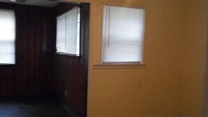 A hallway with two windows, one with blinds and one with a closed shutter. - 4BR Home Minutes from Mercedes‑Benz Stadium — FIFA 2026 Full‑Event Rental (Atlanta)
