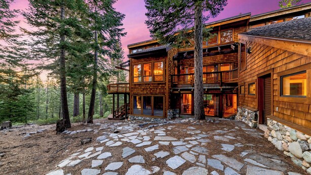 A multi-level wooden cabin with stone flooring, surrounded by trees. - Lx16 Luxe Martis Landing Sauna, Gameroom and Hot Tub (Truckee)