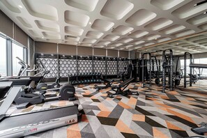 A gym with treadmills, weight machines, and dumbbells. - APEC CHAMPA MUI NE BINH THUAN CONDOTEL (Tuy Hoa)