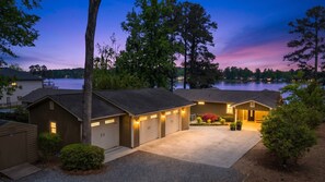A residential property with a garage, a covered driveway, and a lake view. - Best Location On Lake Sinclair (Milledgeville)