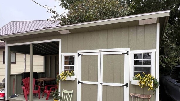 A small shed with a covered porch, a table, and chairs. - Charming Bed & Breakfast! 2 (Estevan)