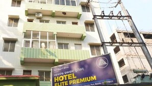 A multi-story building with a sign for 'Sai Gopal Nivas Hotel' and a 'Hotel Elite Premium' advertisement. - Hotel Elite premium (Puri)