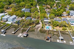 An aerial view of a coastal residential area with houses, a dock, and a swimming pool. - Small Dog(s)|Spa|Arcade|2 Kitchens (By Beach Star) (Murrells Inlet)