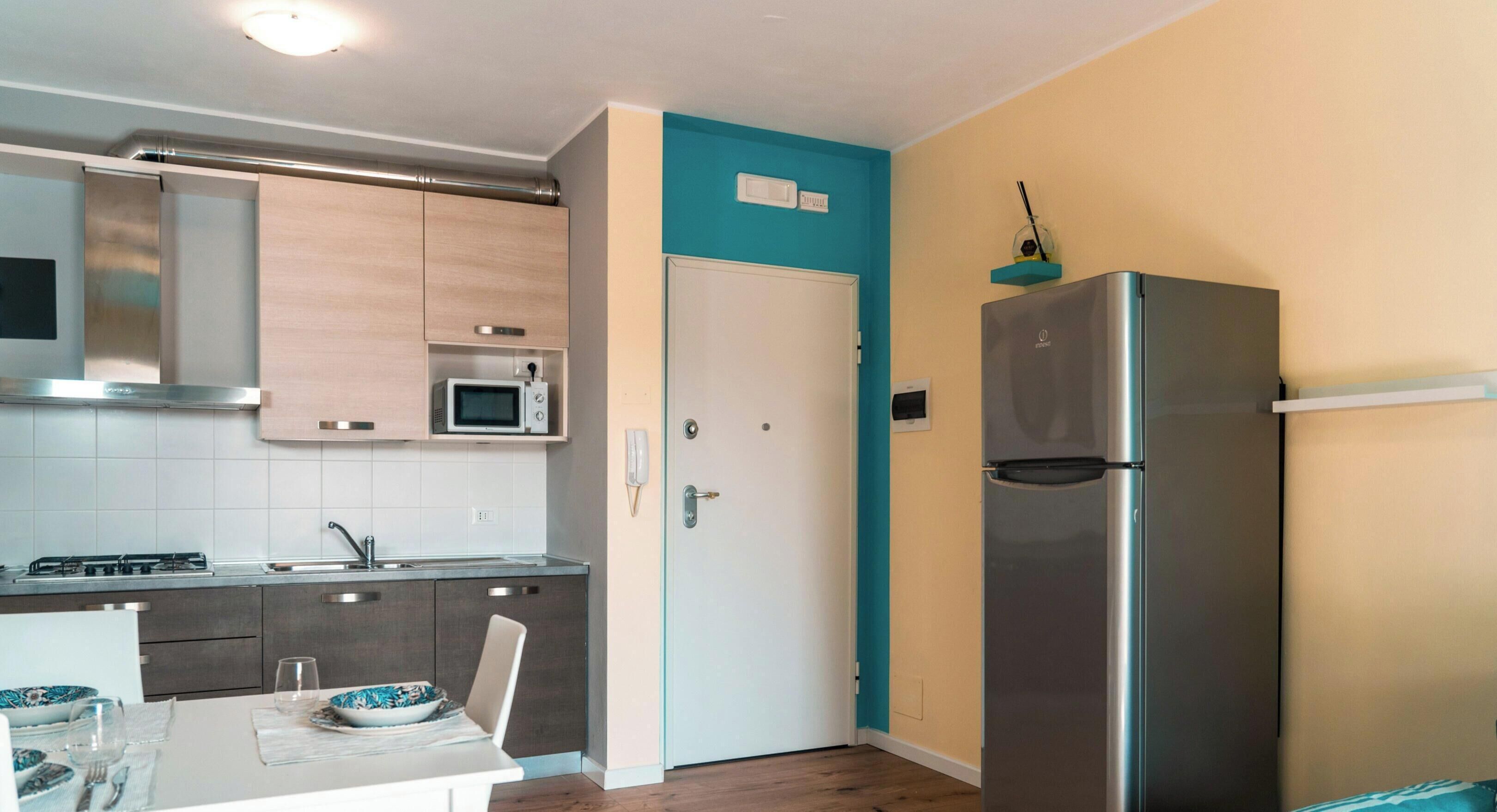 A modern kitchen with a microwave, stove, and refrigerator.