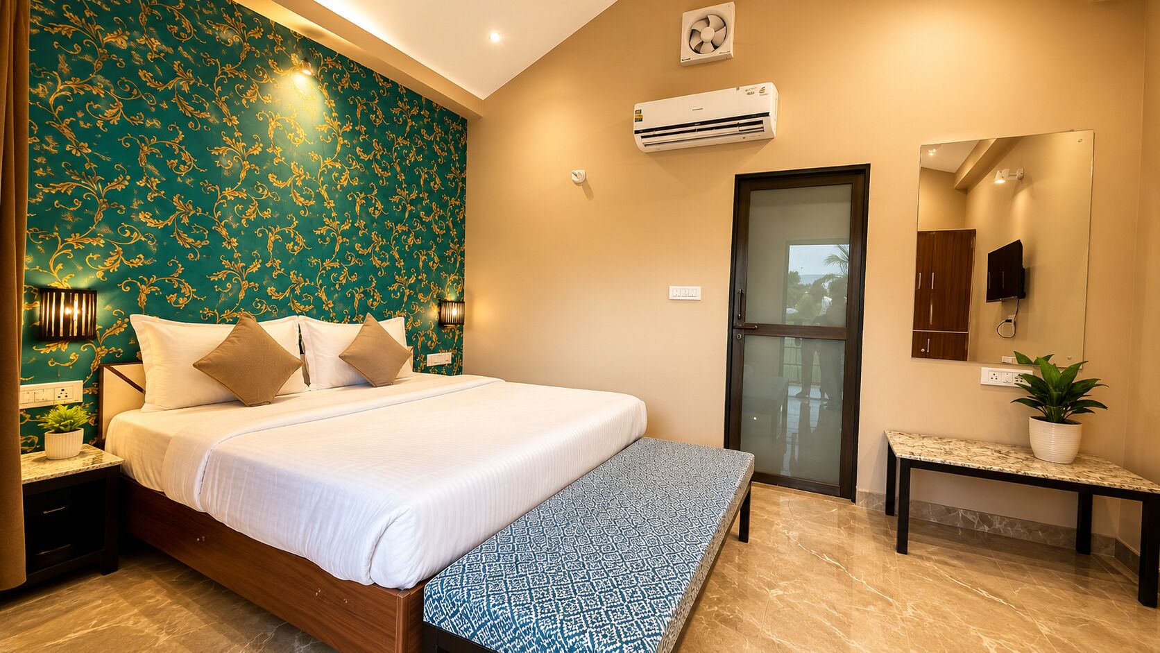 A bedroom with a bed, bedside tables, a bench, an air conditioning unit, a mirror, a door, and a potted plant.