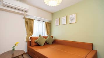 Comfort Apartment, Non Smoking (305) | Living area | 50-inch flat-screen TV with cable channels