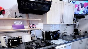 A compact kitchen with a gas stove, coffee maker, and a dishwasher. - Entire London center studio flat Victorian build/quiet/mins tube river/1 shower (London)