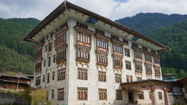 A multi-story building with traditional architectural style, featuring ornate window designs and a flat roof. - Samyae Resort (Jakar)