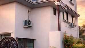 Ein modernes Gebäude mit flachem Dach, zahlreichen Fenstern und einer Klimaanlage.