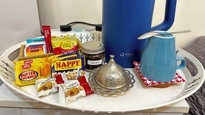 A tray with food items, a blue mug, a jar of Nescafe, and a decorative glass. - Olivia's BNB: Fully furnished private suite in Jimi Ameriya (Al Ain)