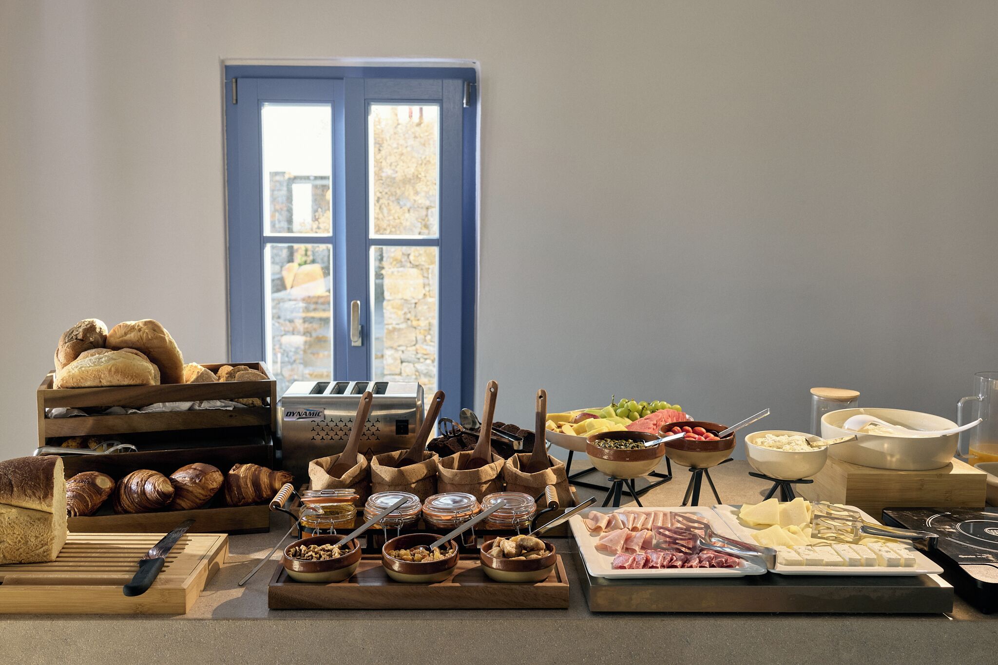 A breakfast buffet with various food items and utensils.