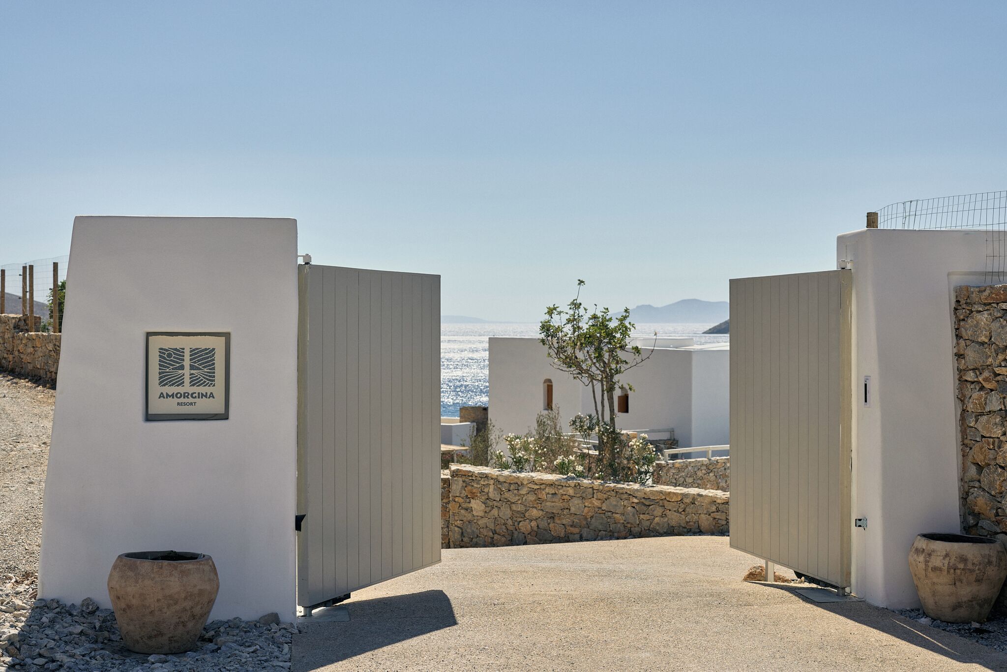 A gated entrance to a property with a sign reading 'AMORGINA RESORT'.
