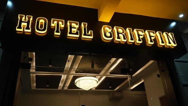A hotel sign with the name 'HOTEL GRIFFIN' illuminated in bright lights. - Hotel Griffin (Anandpur Sahib)