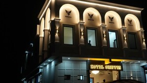 A hotel with arched windows and a sign reading 'HOTEL GRIFFIN.' - Hotel Griffin (Anandpur Sahib)