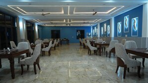 A spacious conference room with a marble floor, arranged seating, and modern lighting. - Hotel Griffin (Anandpur Sahib)