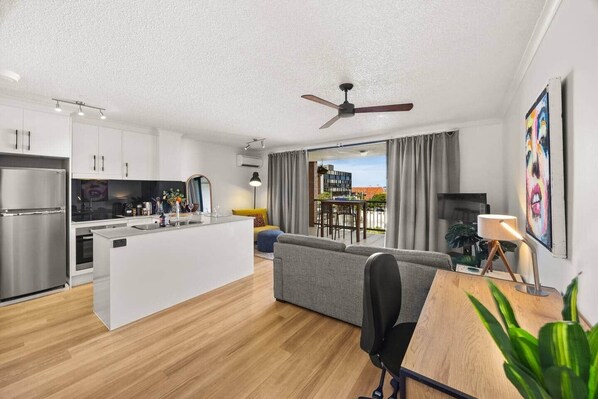 A modern apartment with a kitchen, dining area, and living room. - Galleries Apartments, 1 Bed, Parking, Balcony (Fortitude Valley)