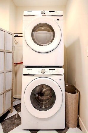 Keep your clothes fresh and clean with our high efficiency Samsung washer and dryer. The tall woven hamper is ready to help you organize your laundry during your stay. - Gorgeous NuLu Retreat | Gated Parking | Two Patios (Louisville)