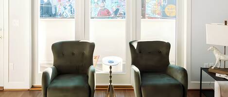 Relax in these two deep emerald green velvet armchairs perfectly positioned by the window. It is the best spot in the house to enjoy the sunlight and a good book.