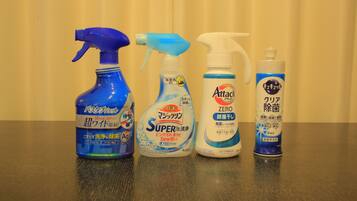 Four bottles of cleaning products on a table.