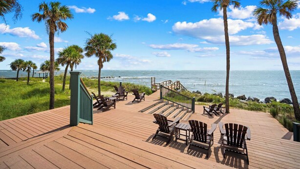 A wooden deck with Adirondack chairs overlooking the ocean. - New to VRBO 3 Bedroom Villa - Golf cart included - 604 Newhaven (Fripp Island)