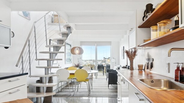 A modern kitchen with a wooden countertop, stainless steel sink, and a spiral staircase. - "Pejo" - 10m from the sea by Interhome (Glesborg)