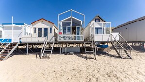 Beachside mobile homes with external staircases leading to the upper levels. - Slaapstrandhuisje - Strand Dishoek 37 I Dishoek (Koudekerke)